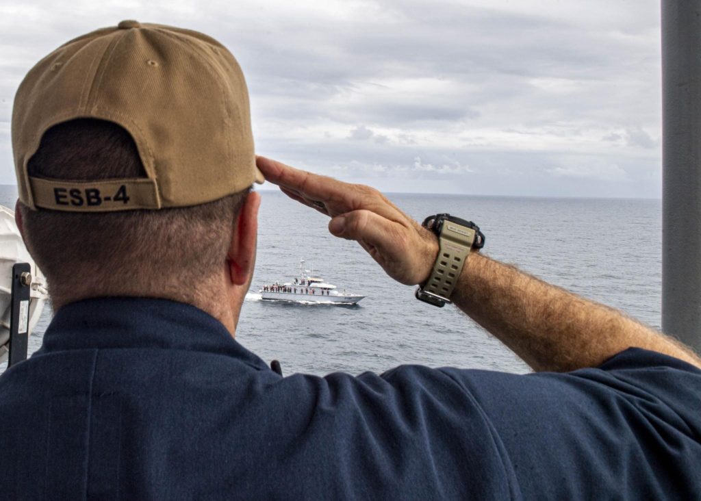 David Gray, commanding officer of the Expeditionary Sea Base USS Hershel "Woody" Williams salute the Nigerian Navy patrol craft NNS Ekulu| photography by Seaman Conner Foy