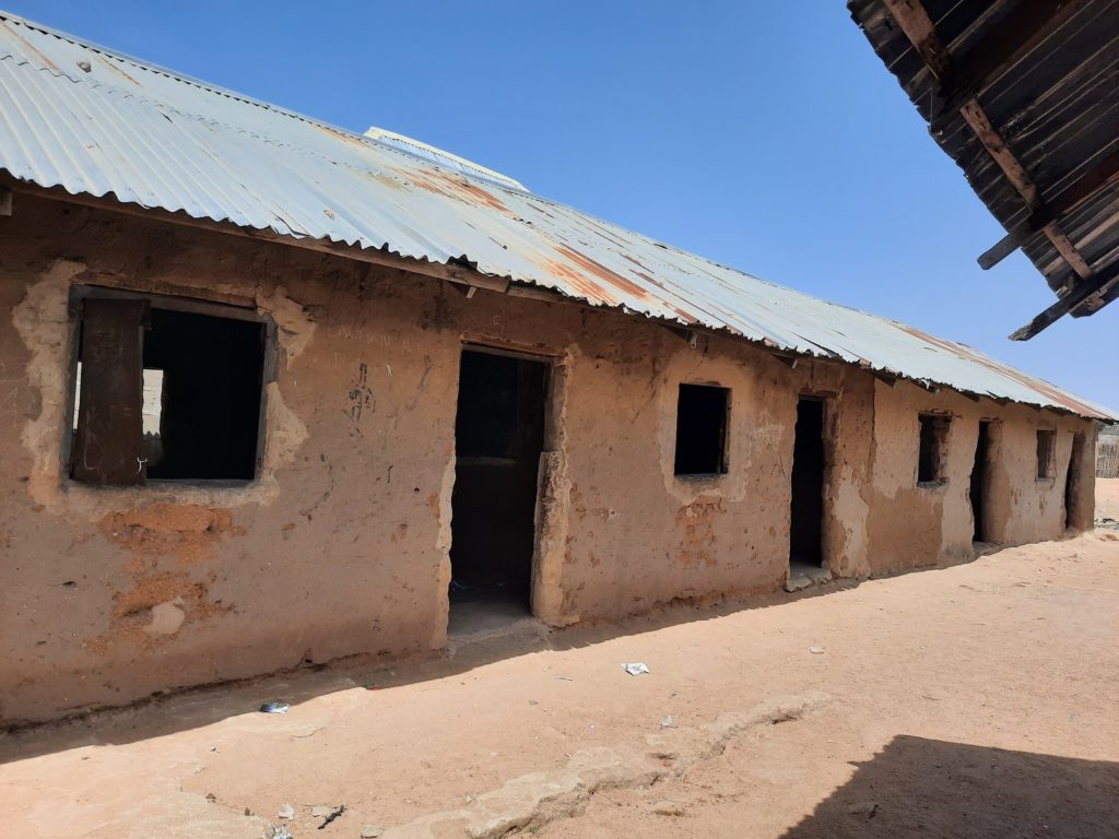 This almajiri school in Bauchi has mud classrooms and cemented floors but no doors, windows, or items of furniture. The children sit on the floor to receive lectures.