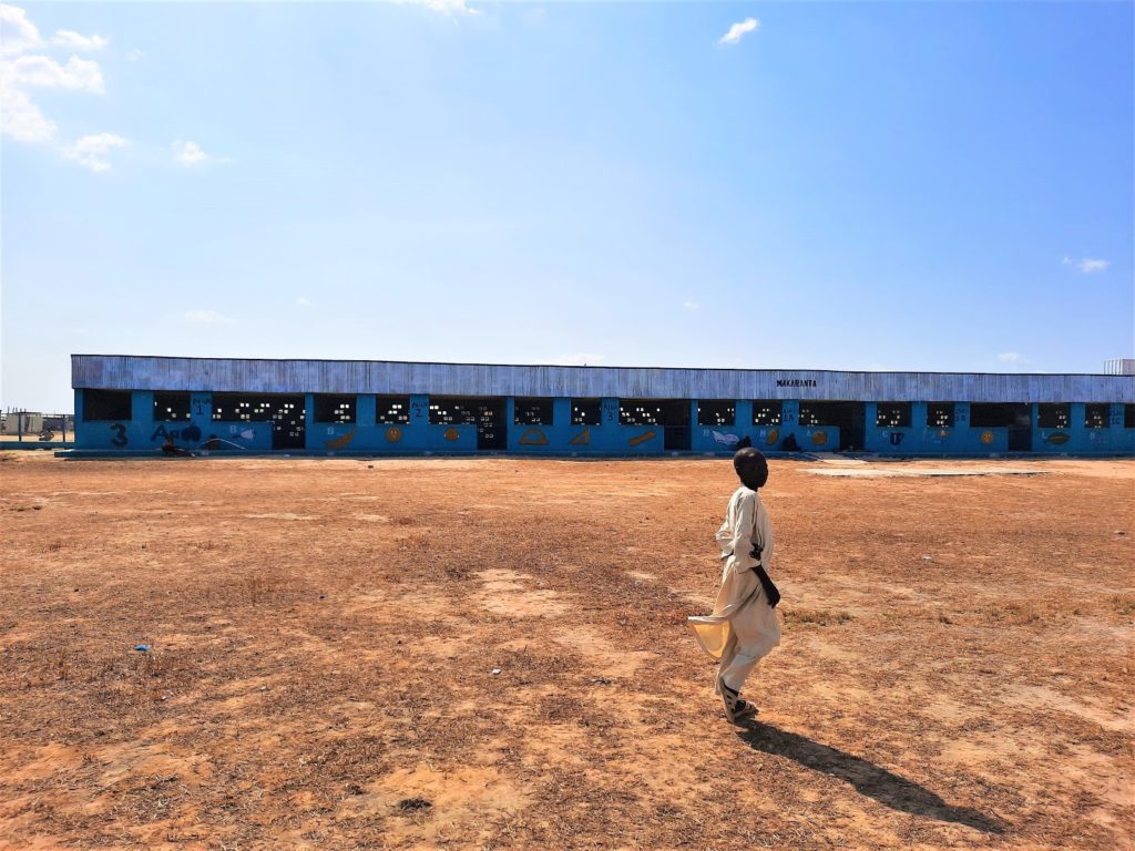 A boy walks across the premises of the primary school at Bakassi IDP camp, Maiduguri. Many displaced children are unable to advance to higher classes after graduating from the school due to a lack of resources.